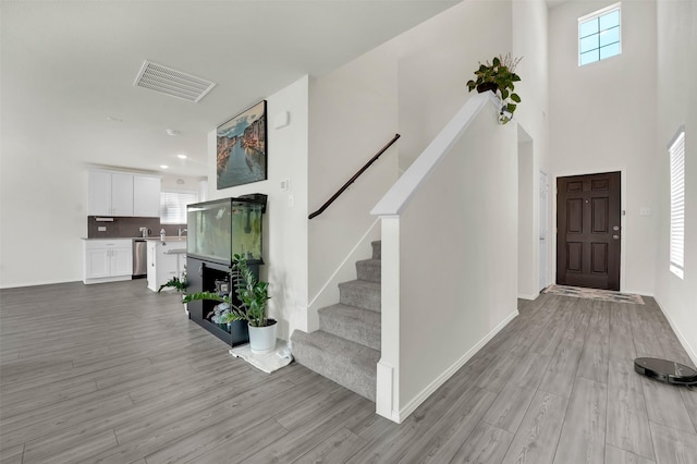 1335 Panorama Dr, Forney, TX 75126 - foyer with visible vents, baseboards, a high ceiling, light wood finished floors, and stairway