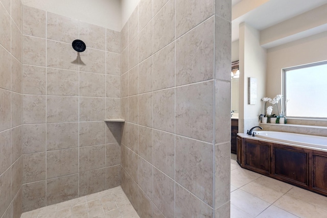 bathroom featuring a bath, tile patterned flooring, and a tile shower