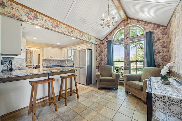 6 Broadmoor Way, Lucas, TX 75098 - kitchen featuring a chandelier, freestanding refrigerator, wallpapered walls, a peninsula, and backsplash