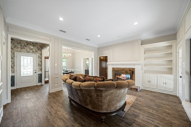 6 Broadmoor Way, Lucas, TX 75098 - living room with ornamental molding, dark wood finished floors, a chandelier, a fireplace, and a decorative wall