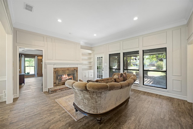 6 Broadmoor Way, Lucas, TX 75098 - living area featuring crown molding, wood finished floors, a brick fireplace, recessed lighting, and a decorative wall