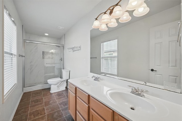 full bath featuring double vanity, toilet, a sink, and a stall shower