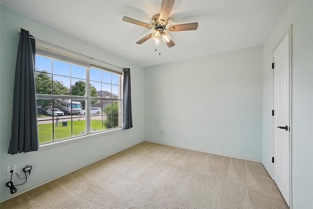 unfurnished room with baseboards, carpet, and ceiling fan