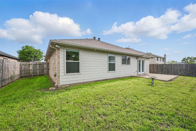 rear view of house with a patio, a fenced backyard, and a yard