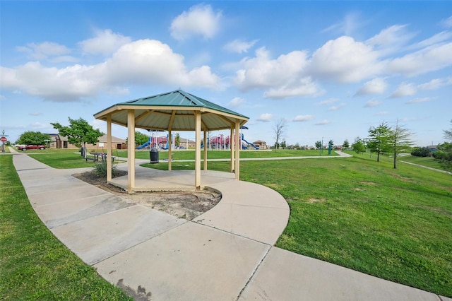 view of home's community featuring a lawn and playground community