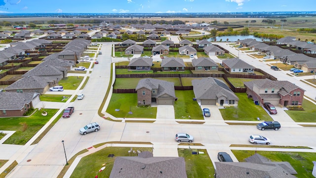 bird's eye view with a residential view and a water view
