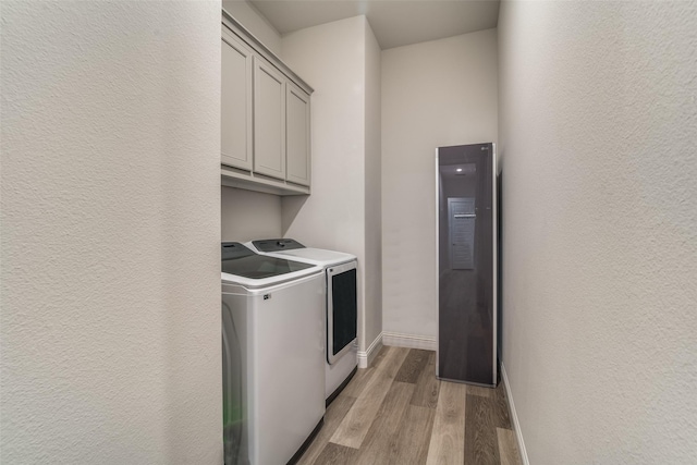 1314 Middleton Dr, Rockwall, TX 75087 - washroom with washer and clothes dryer, a textured wall, cabinet space, light wood-style flooring, and baseboards