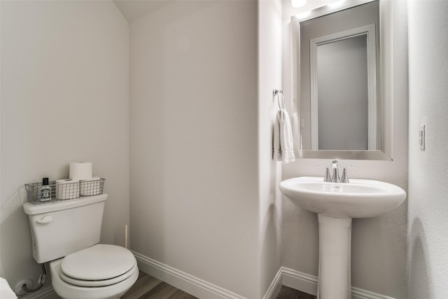 1314 Middleton Dr, Rockwall, TX 75087 - half bath with toilet, wood finished floors, a sink, and baseboards