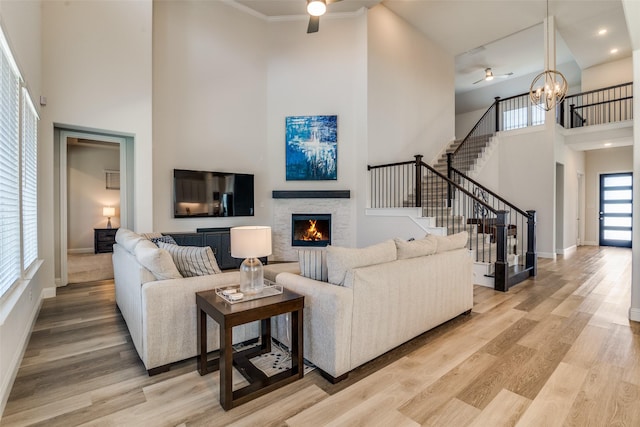 1314 Middleton Dr, Rockwall, TX 75087 - living room with baseboards, a high ceiling, light wood-type flooring, a fireplace, and stairs
