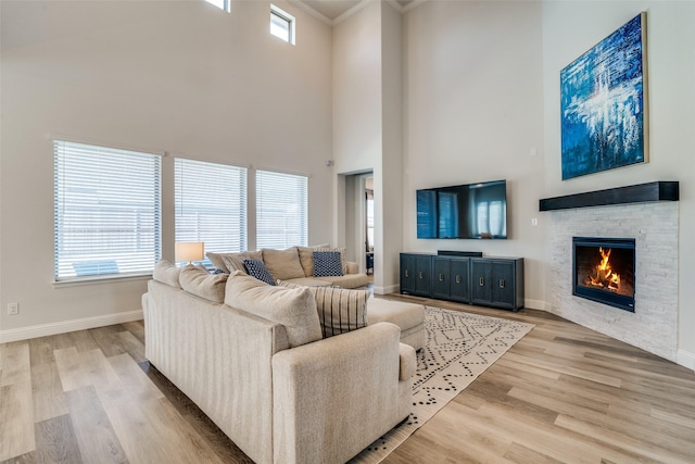 1314 Middleton Dr, Rockwall, TX 75087 - living area featuring baseboards, a high ceiling, ornamental molding, a fireplace, and wood finished floors
