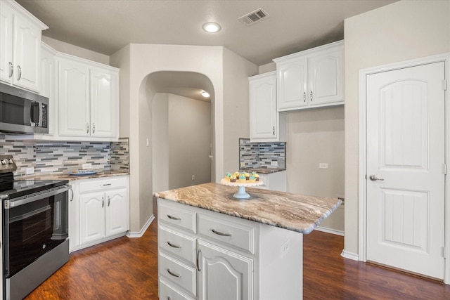 1509 Salado Trl, Weatherford, TX 76087 - kitchen with stainless steel appliances, visible vents, white cabinetry, and dark wood finished floors