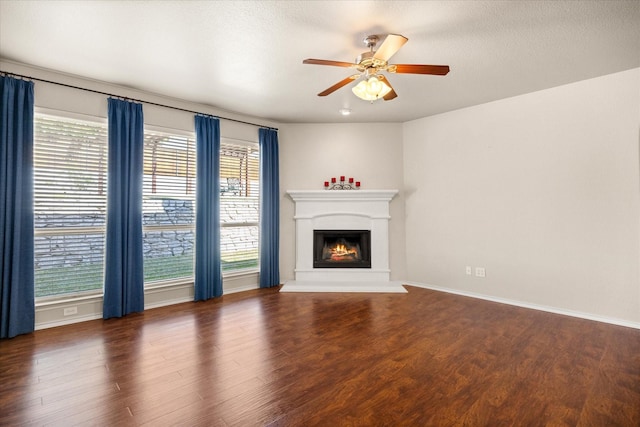 1509 Salado Trl, Weatherford, TX 76087 - unfurnished living room with a healthy amount of sunlight, ceiling fan, and a warm lit fireplace