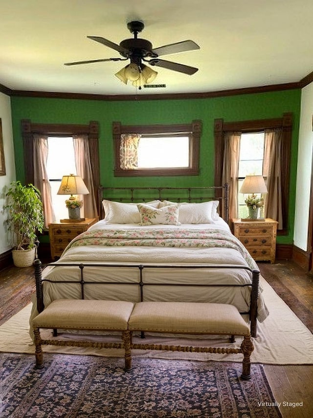 bedroom with baseboards, a ceiling fan, wood finished floors, and ornamental molding
