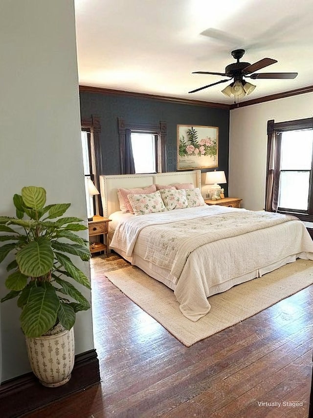 bedroom featuring wood finished floors, a ceiling fan, and ornamental molding