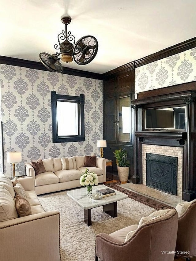 living area featuring crown molding, a brick fireplace, and wallpapered walls
