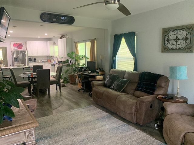 living area with ceiling fan, recessed lighting, and wood finished floors