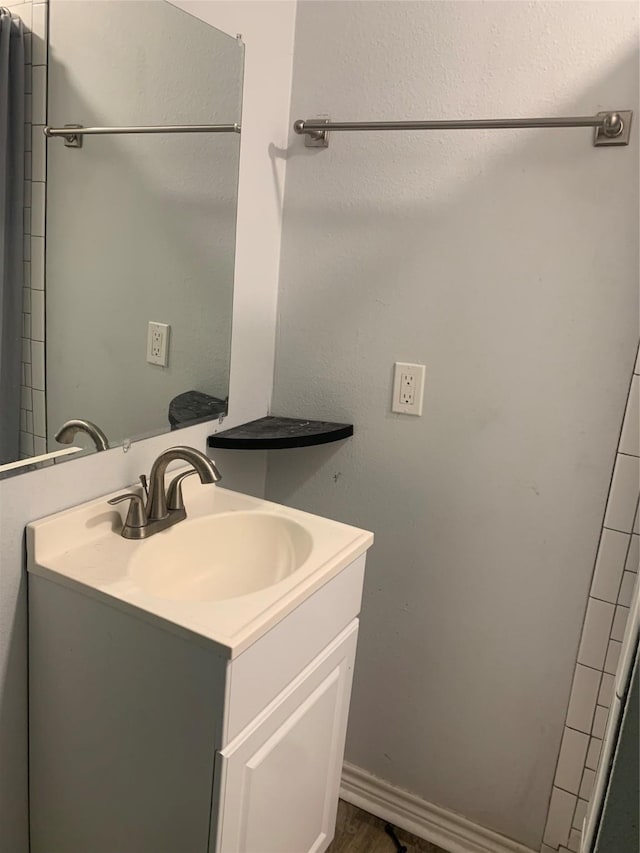bathroom featuring wood finished floors and vanity