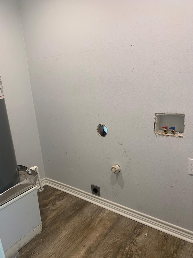 clothes washing area with baseboards, hookup for an electric dryer, wood finished floors, and laundry area