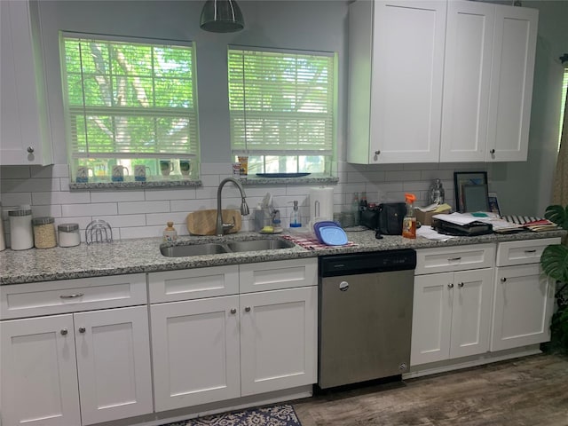 kitchen with a sink, decorative backsplash, dishwasher, and white cabinets