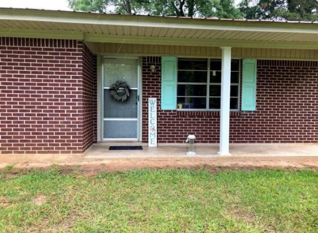 property entrance featuring brick siding