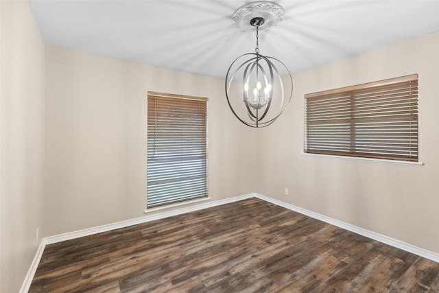 800 Western Hills Dr, Sherman, TX 75092 - unfurnished room featuring dark wood-type flooring, baseboards, and an inviting chandelier