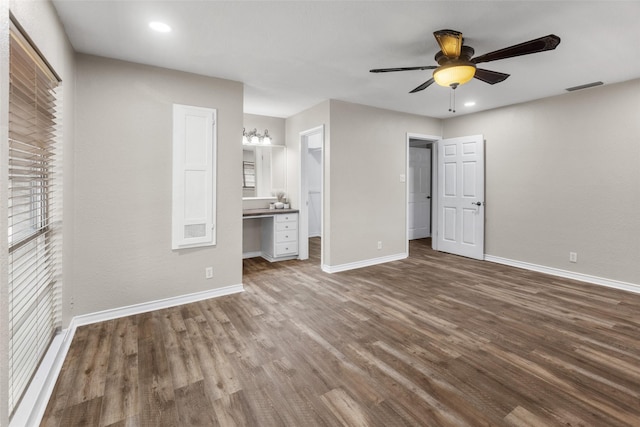800 Western Hills Dr, Sherman, TX 75092 - unfurnished bedroom with baseboards, a walk in closet, visible vents, ceiling fan, and wood finished floors