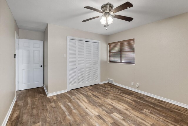 800 Western Hills Dr, Sherman, TX 75092 - unfurnished bedroom with visible vents, baseboards, a closet, a ceiling fan, and wood finished floors