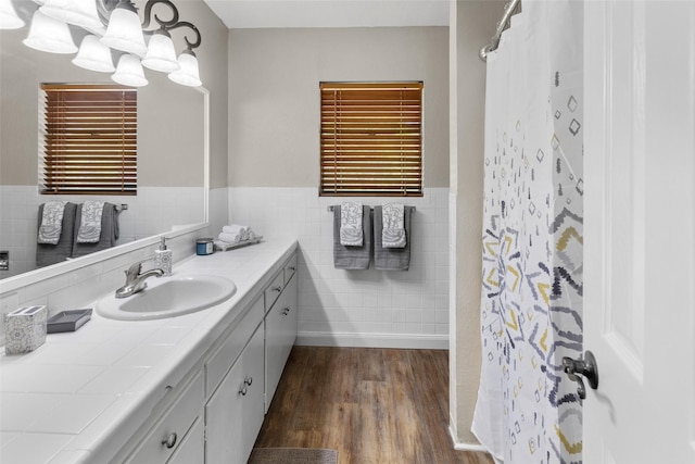 800 Western Hills Dr, Sherman, TX 75092 - full bath with a shower with curtain, tile walls, vanity, wood finished floors, and a wainscoted wall