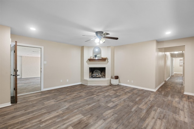 800 Western Hills Dr, Sherman, TX 75092 - unfurnished living room featuring wood finished floors, a large fireplace, baseboards, and a ceiling fan