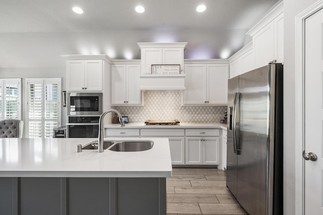 kitchen with a sink, light countertops, white cabinetry, and stainless steel appliances