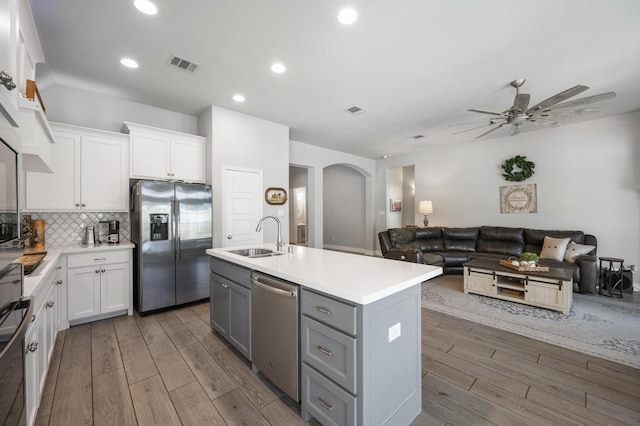 kitchen featuring ceiling fan, visible vents, gray cabinets, a sink, and stainless steel appliances