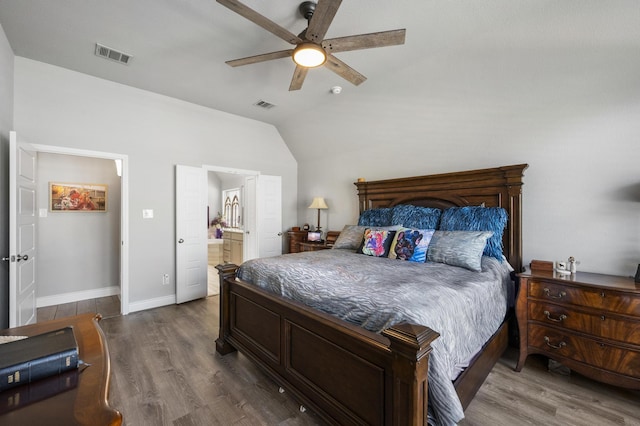 bedroom featuring dark wood-style floors, visible vents, baseboards, and lofted ceiling