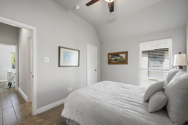 bedroom featuring ceiling fan, baseboards, and lofted ceiling