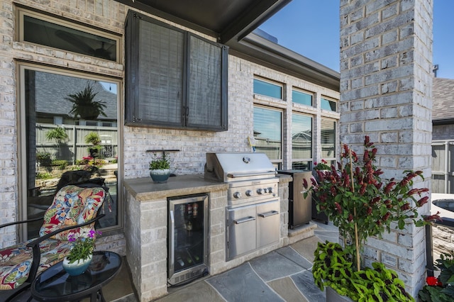 view of patio with a grill, exterior kitchen, and beverage cooler