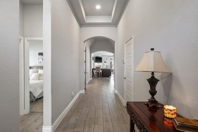2616 Lazy Dog Ln, Northlake, TX 76247 - hallway featuring arched walkways, light wood-style flooring, and baseboards