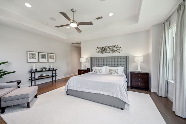 3912 Holland Ave, Dallas, TX 75219 - bedroom with a raised ceiling, dark wood finished floors, recessed lighting, baseboards, and ceiling fan