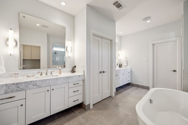 3912 Holland Ave, Dallas, TX 75219 - bathroom featuring vanity, a soaking tub, a stall shower, recessed lighting, and baseboards