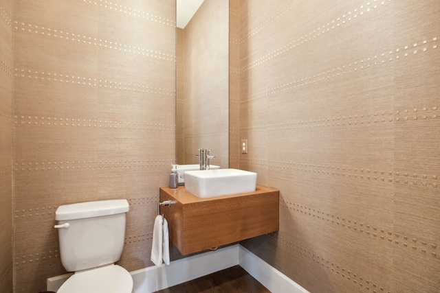 3912 Holland Ave, Dallas, TX 75219 - half bath featuring toilet, wood finished floors, and vanity