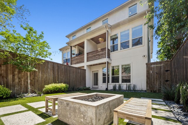 3912 Holland Ave, Dallas, TX 75219 - rear view of property with stucco siding and a balcony