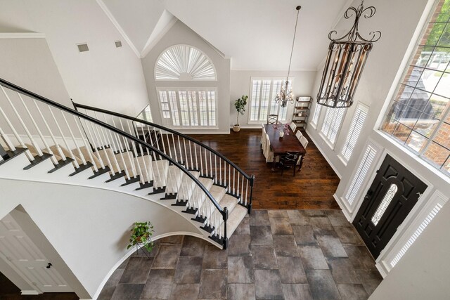 5800 Edgewood Dr, Mckinney, TX 75072 - foyer entrance featuring plenty of natural light, high vaulted ceiling, stairway, and an inviting chandelier
