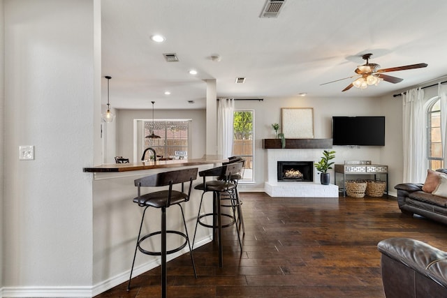 5800 Edgewood Dr, Mckinney, TX 75072 - living room with visible vents, baseboards, and dark wood-style floors