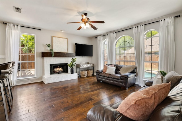 5800 Edgewood Dr, Mckinney, TX 75072 - living room featuring a fireplace, wood-type flooring, a ceiling fan, and visible vents