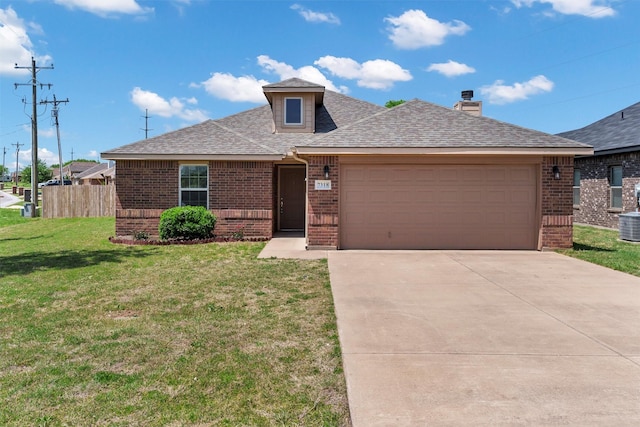 view of front of home featuring brick siding, a front lawn, a garage, and roof with shingles