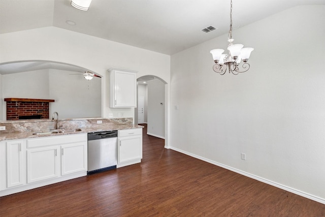 kitchen with ceiling fan with notable chandelier, stainless steel dishwasher, arched walkways, a sink, and dark wood-style floors
