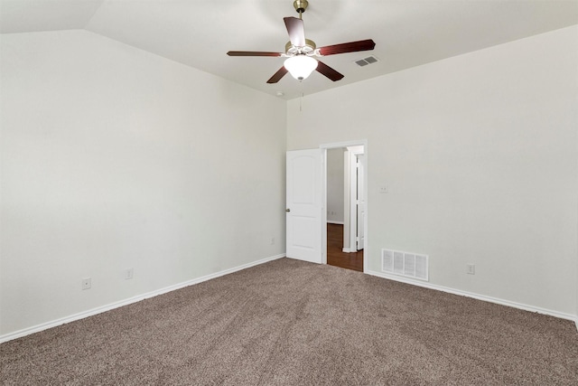 empty room featuring visible vents, baseboards, ceiling fan, vaulted ceiling, and carpet flooring
