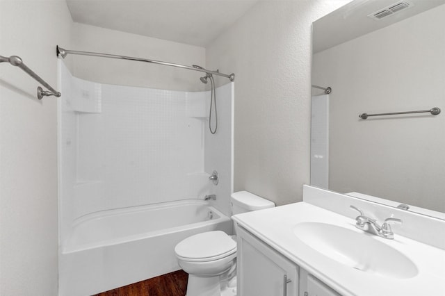 bathroom with vanity, visible vents, toilet, shower / bath combination, and wood finished floors