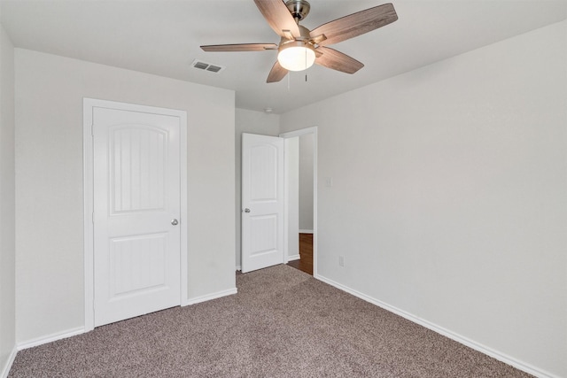 unfurnished bedroom featuring carpet flooring, visible vents, baseboards, and ceiling fan
