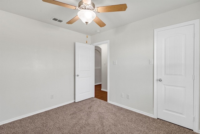 unfurnished bedroom featuring visible vents, baseboards, ceiling fan, and carpet