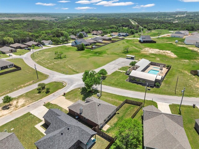 bird's eye view featuring a wooded view and a residential view