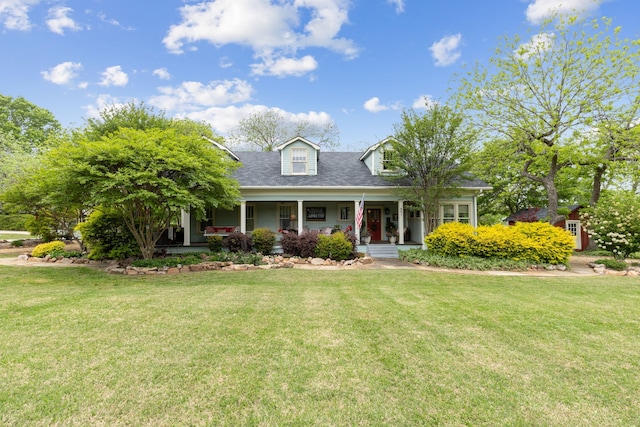 cape cod home featuring a front lawn, roof with shingles, and a porch